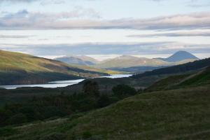 a view of a valley with a lake and mountains at Killoran House in Dervaig
