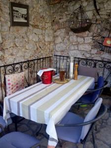 a table with a striped table cloth on it at Apartman i Sobe Čule Cres in Cres