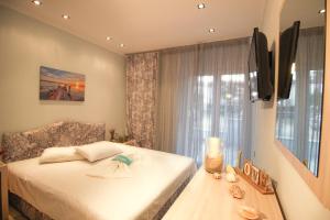 a small bedroom with a bed and a window at Athena's Studios in Polychrono