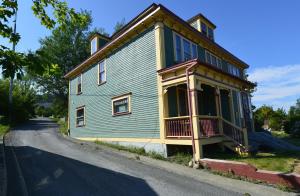 a house that is sitting on the side of a road at The Spaniards Room Heritage Home in Spaniards Bay