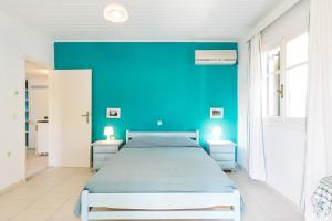 a blue bedroom with a bed with blue walls at Panorama Apartments updated with infinity pool in Agios Nikolaos
