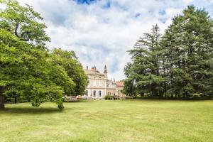 an old castle with trees in front of it at Chateau de Bournet in Grospierres