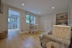 a living room with a couch and a table at Pippin Heath House B&B in Holt