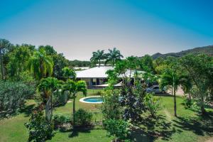 an aerial view of a house with a pool and trees at Magnetic Island Bed and Breakfast in Horseshoe Bay