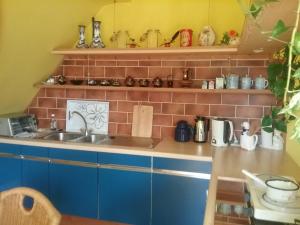 a kitchen with a sink and a brick wall at Gudrun Waegner in Welcherath