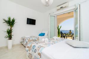 a bedroom with a bed and a view of the ocean at Apartments A&M in Mlini