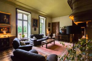 a living room with a couch and a table at Chateau de Bournet in Grospierres