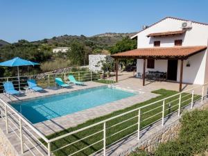 a villa with a swimming pool and a house at Villa Adriana in Arménoi