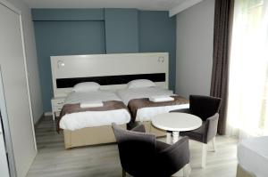 Postel nebo postele na pokoji v ubytování Pruva Prestige Hotel