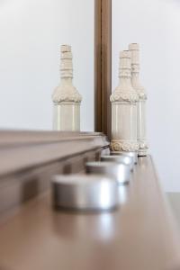 a row of glass bottles sitting on top of a table at Memories Beach Hotel in Monolithos