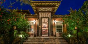 an exterior view of a house with a gate and stairs at Pedra da Laguna Boutique Hotel SPA in Búzios