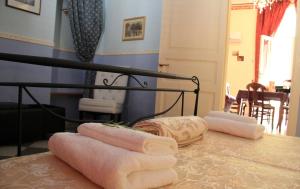 a group of towels sitting on top of a table at Antica Corte delle Ninfee, Historical Private Villa in Trapani