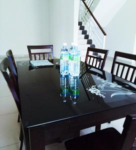a black table with two bottles of water on it at Sri Manjung Ma Maison Homestay in Lumut +5 photos