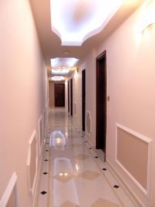 a hallway with a white tile floor and a skylight at Ellinis Hotel in Chania