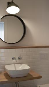 a white sink sitting under a mirror in a bathroom at Aparthotel Fleming 50 - Adults Only in San Antonio
