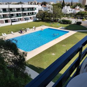 a view of the pool from the balcony of a building at Hello Sun in Vilamoura