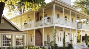 a large white building with a porch and balcony at Tallman Hotel in Upper Lake