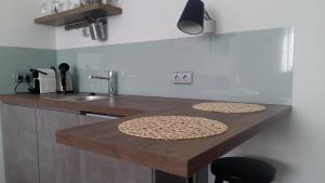 a kitchen with a wooden counter top with a sink at Studia Letců 2A in Olomouc