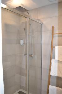 a shower with a glass door in a bathroom at 2 pièces Vagliano in Cannes