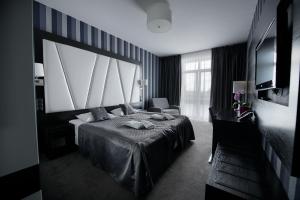 Postel nebo postele na pokoji v ubytování Hotel Grafit