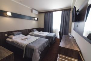 Postel nebo postele na pokoji v ubytování Zinedine Sport-Hotel + 37 fotografií