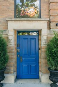 a blue door on a brick building with a sign above it at The Publishing House Bed and Breakfast in Chicago