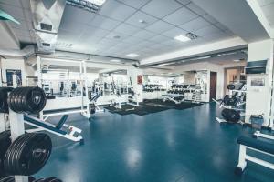 a gym with dumbbells and other equipment in it at Zinedine Sport-Hotel in Uzhhorod