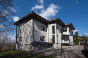 a white house with a black roof at Nuustaku Villa in Otepää