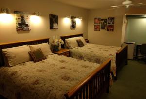 a bedroom with a bed, a desk, and a painting on the wall at Cedar Wood Lodge Bed & Breakfast Inn in Port Alberni