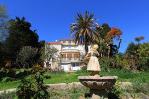 a statue of a girl in a fountain in front of a house at Apartment MiraMare on the beach in Split