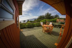 a view of a deck with a table and chairs at En Casa de Patricia in Laguna Verde