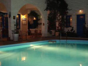 a large swimming pool in a house with at Creta Sun Hotel Studios in Agia Pelagia