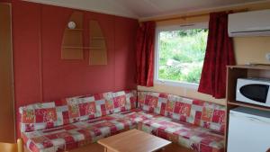 a living room with a couch and a window at La Canardiere in Casta