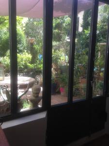 a window view of a patio with a table at Rose-INN appartement in Orange