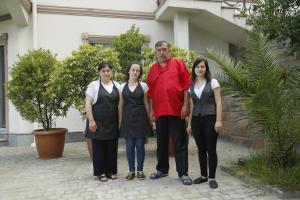 a man and three women standing in front of a house at Mount Villa Kvariati in Kvariati