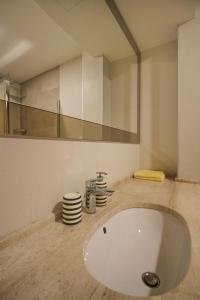 a bathroom with a large white sink and a mirror at Lux Apartment Lazarevic in Zlatibor