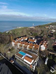 an aerial view of a building with the ocean at Plażowa 5 in Rowy
