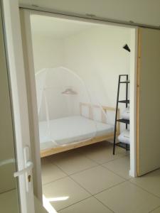 a bed in a room with a glass door at En camargue in Salin-de-Giraud