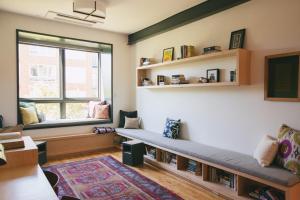 a living room with a bench and a window at The Publishing House Bed and Breakfast in Chicago