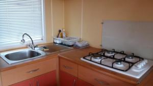 a kitchen with a stove and a sink at La Canardiere in Casta