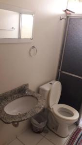 a bathroom with a toilet and a sink at Acquaville Flat in Caldas Novas