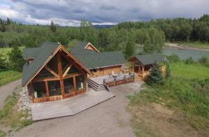 an overhead view of a log cabin with a porch at LDR Lodge - Last Dollar Ranch in Smithers