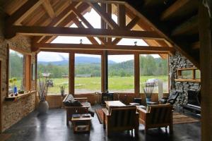 a large open living room with a large window at LDR Lodge - Last Dollar Ranch in Smithers