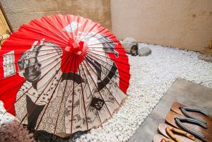 a red umbrella sitting on a pile of rocks at Kyo Yukari in Kyoto