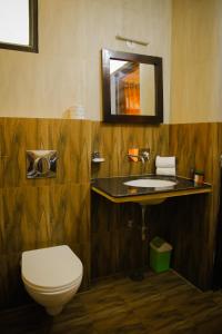 a bathroom with a toilet and a sink at Nahar Singh Haveli in Jaipur