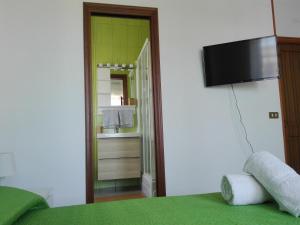 a bedroom with a bed and a bathroom with a sink at I Sogni di Morfeo in Termoli