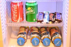 a refrigerator filled with drinks and toothbrushes and candy at Orient Hotel in Nablus