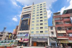 a tall building in the middle of a city at Palmer Hotel in Taichung