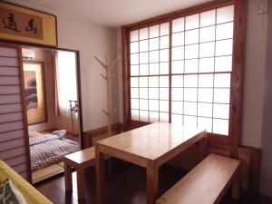 堺市にあるコンドミニオ百舌鳥１０２ のテーブル、鏡、ベッド1台が備わる客室です。