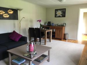 a living room with a couch and a table at Bed & Breakfast Kortenhoefsedijk in Kortenhoef